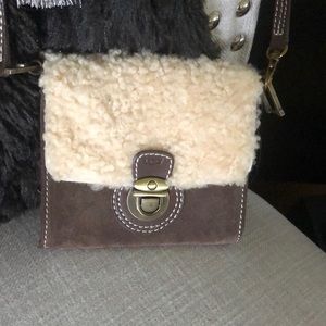 Ugg suede and shearling crossbody dust bag included.